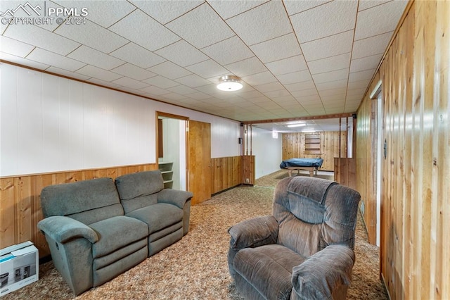 living room with carpet flooring and wooden walls