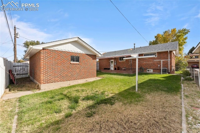 rear view of property featuring a yard