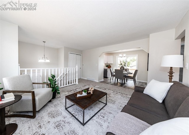 living room with light hardwood / wood-style flooring and a chandelier