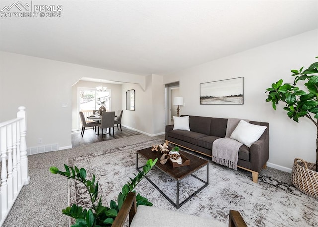 living room featuring carpet floors and a chandelier