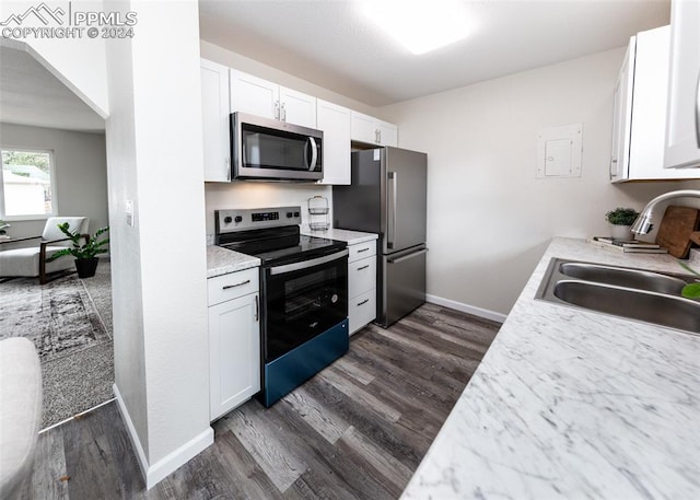 kitchen featuring stainless steel appliances, white cabinetry, sink, and dark hardwood / wood-style flooring