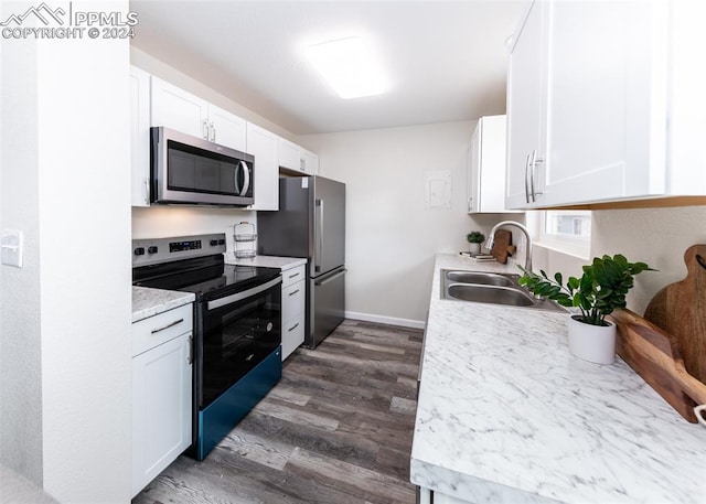 kitchen with white cabinets, appliances with stainless steel finishes, sink, and dark hardwood / wood-style flooring