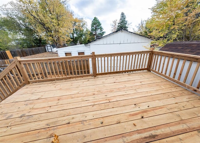 wooden terrace featuring a shed