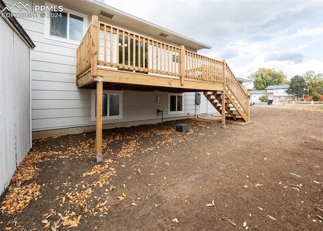 back of house with a wooden deck