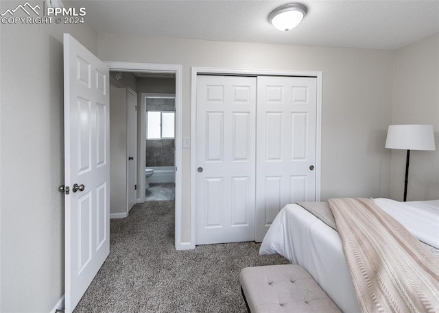 carpeted bedroom featuring a textured ceiling and a closet