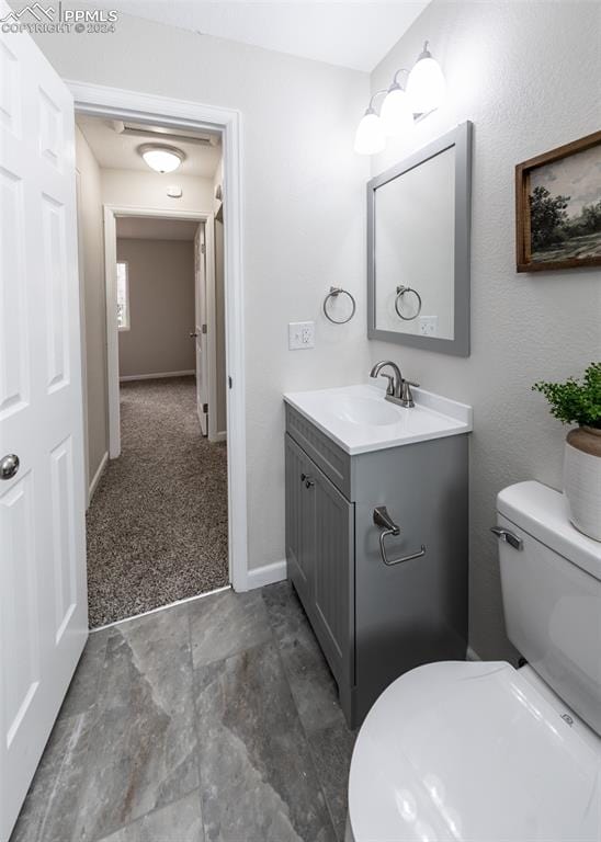 bathroom featuring vanity and toilet