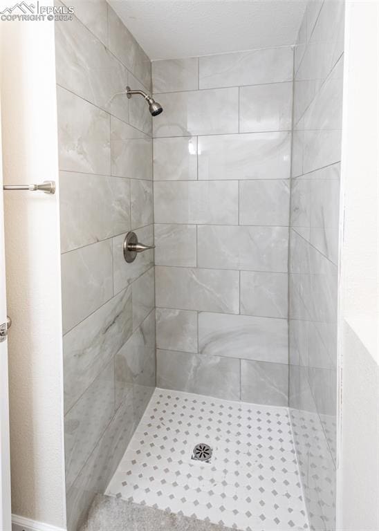 bathroom with tiled shower