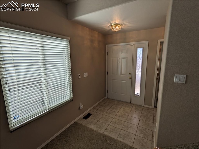 foyer with plenty of natural light and light tile patterned floors