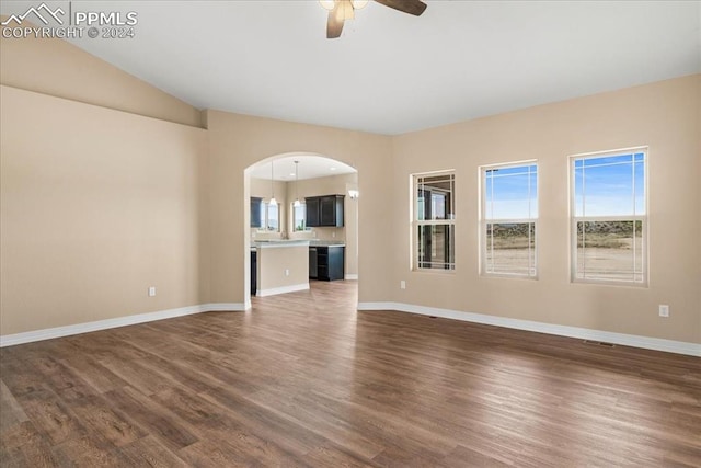 unfurnished living room featuring dark hardwood / wood-style floors and ceiling fan