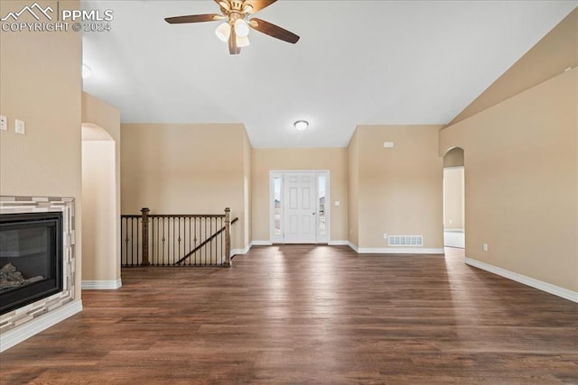 unfurnished living room with dark wood-type flooring, ceiling fan, and vaulted ceiling