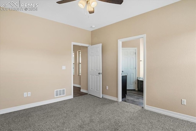 unfurnished bedroom with ensuite bath, ceiling fan, and carpet floors