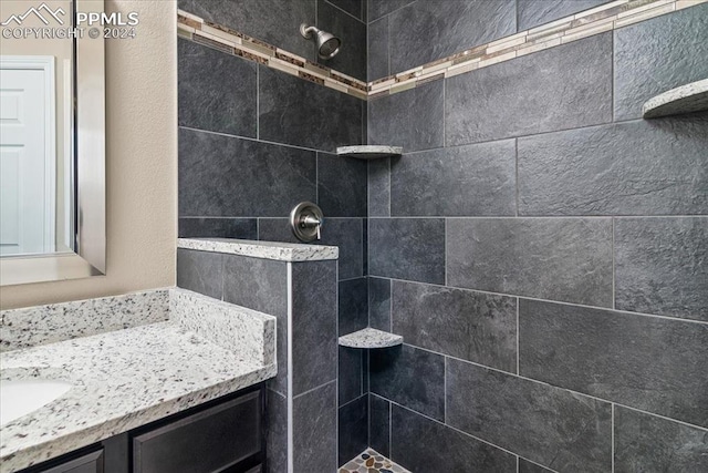 bathroom featuring vanity and a tile shower