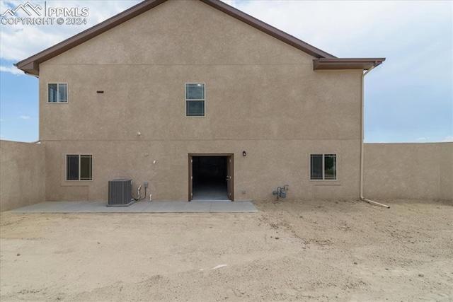 rear view of property featuring central AC and a patio area