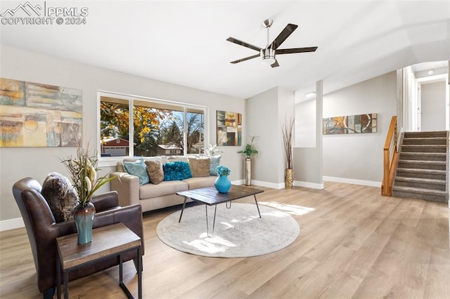 living room featuring light hardwood / wood-style floors, ceiling fan, and lofted ceiling