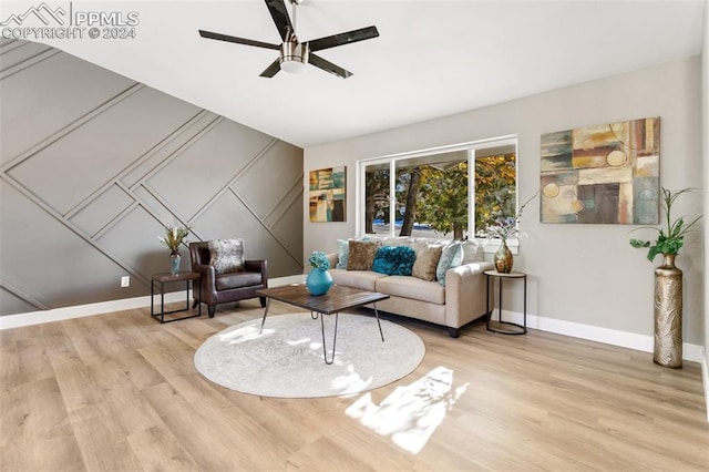 living room with ceiling fan and light hardwood / wood-style flooring