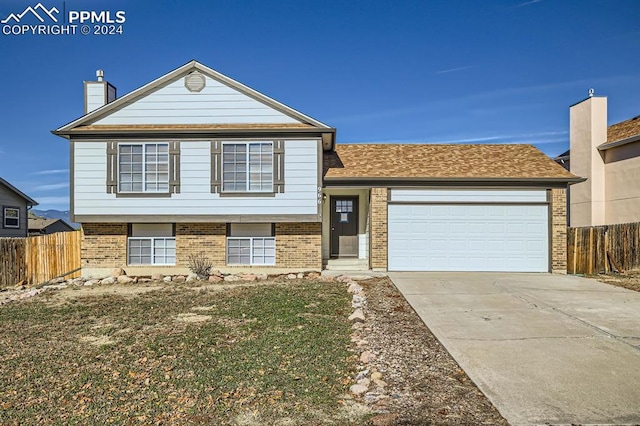 966 Daffodil St, Fountain, CO 80817 - tri-level home featuring brick siding, fence, and concrete driveway