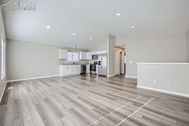 966 Daffodil St, Fountain, CO 80817 - unfurnished living room featuring baseboards, light wood-style floors, high vaulted ceiling, and recessed lighting