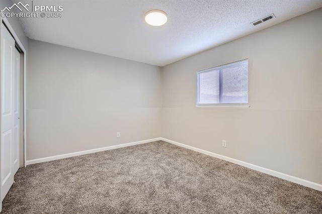 966 Daffodil St, Fountain, CO 80817 - unfurnished bedroom with carpet floors, baseboards, a closet, and a textured ceiling