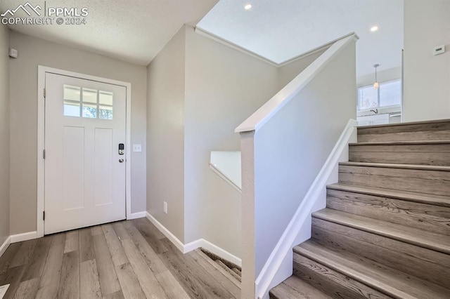 966 Daffodil St, Fountain, CO 80817 - foyer entrance featuring wood finished floors, baseboards, stairs, and recessed lighting
