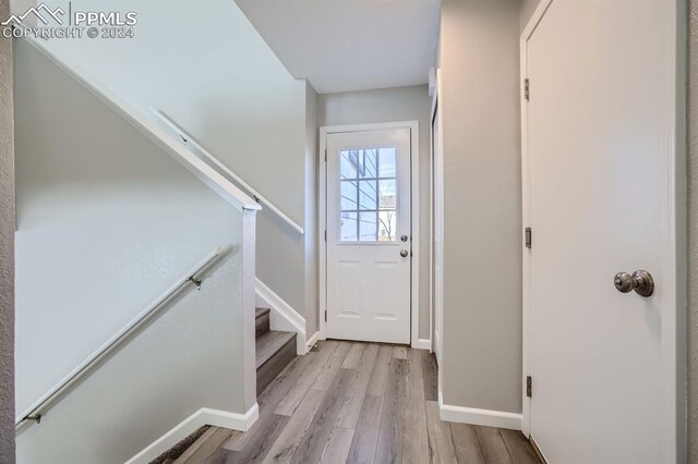 966 Daffodil St, Fountain, CO 80817 - entryway with light wood-style floors, baseboards, and stairs