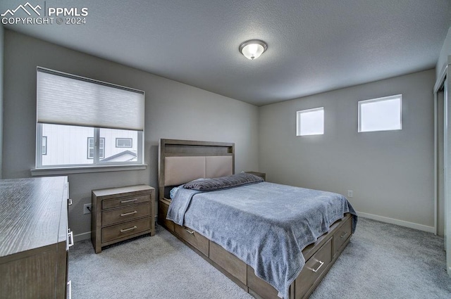 carpeted bedroom with a textured ceiling