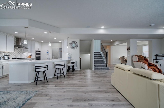 living room with light wood-type flooring and sink