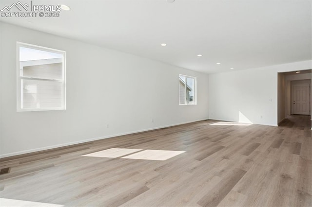 spare room with recessed lighting, light wood-type flooring, visible vents, and baseboards