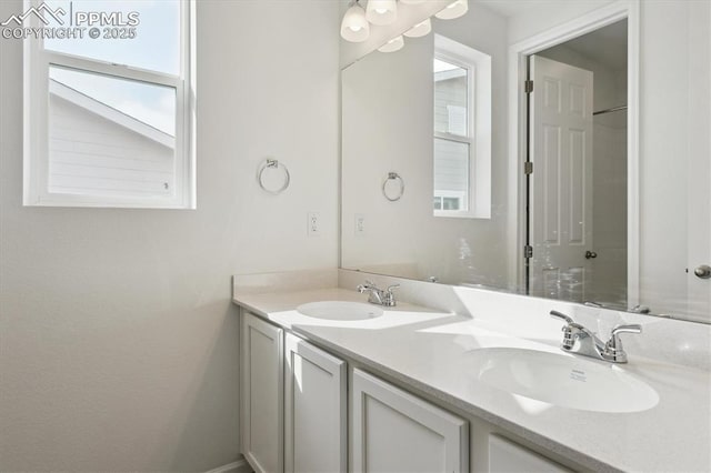 full bath with double vanity and a sink