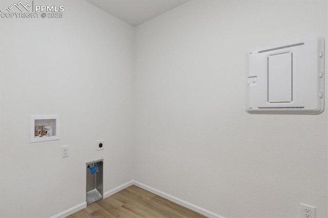 laundry room with baseboards, laundry area, hookup for a washing machine, light wood-style flooring, and electric dryer hookup