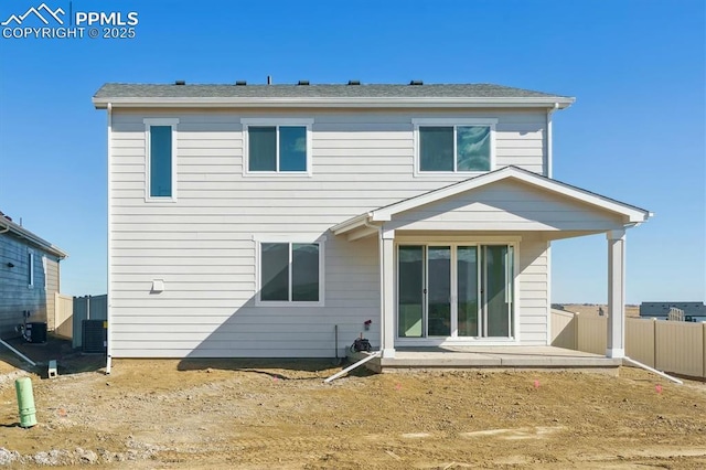 rear view of house featuring central AC unit, fence, and a patio area