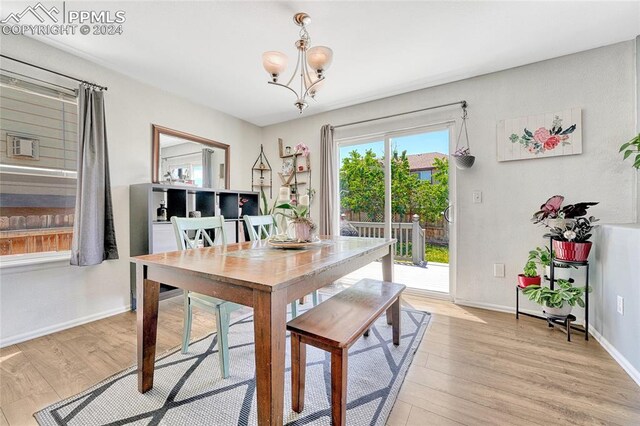 dining room featuring light hardwood / wood-style floors and an inviting chandelier