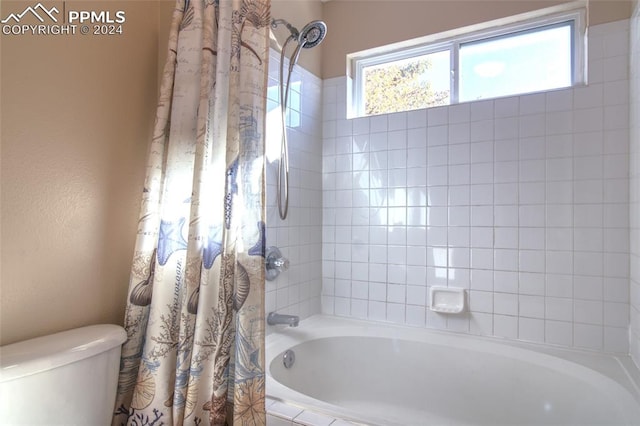 bathroom with shower / bath combo with shower curtain and toilet