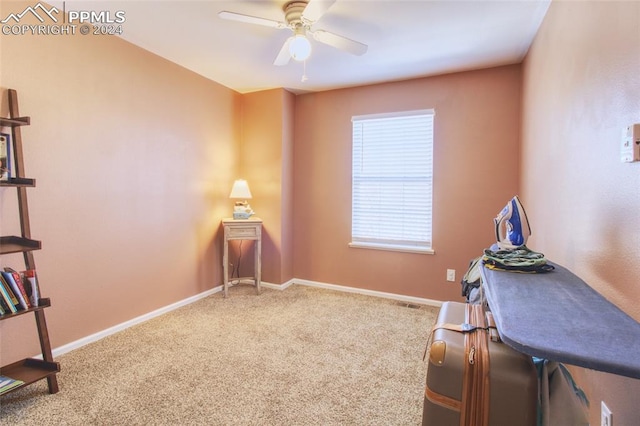 carpeted office with ceiling fan