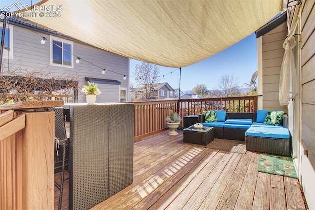 wooden terrace with an outdoor hangout area