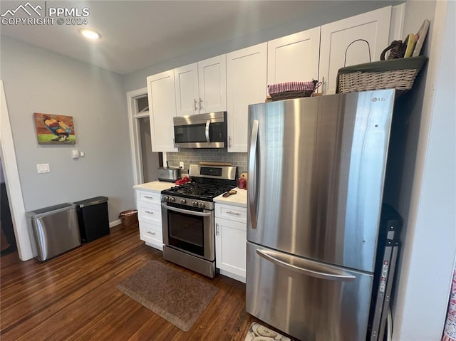 kitchen with white cabinets, decorative backsplash, dark hardwood / wood-style flooring, and stainless steel appliances