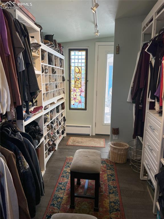 mudroom featuring vaulted ceiling, track lighting, dark hardwood / wood-style floors, and a baseboard heating unit