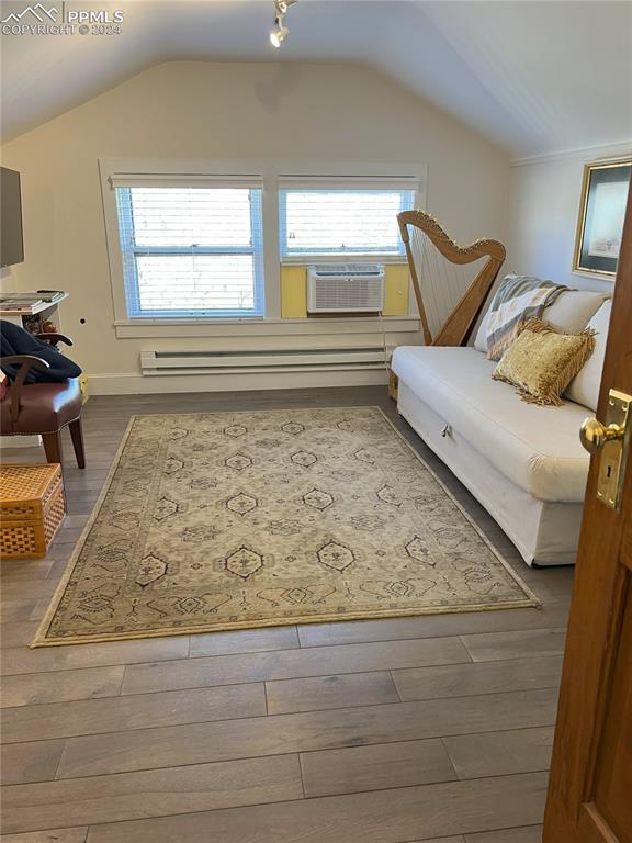 822 Willow St, Trinidad, CO 81082 - living area featuring lofted ceiling, cooling unit, and wood finished floors