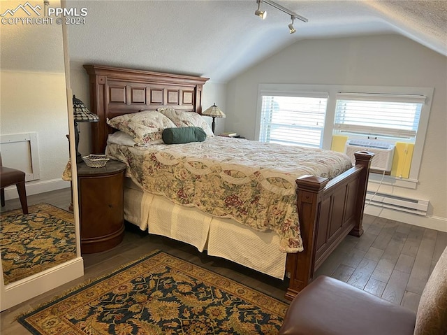 bedroom featuring dark hardwood / wood-style flooring, a textured ceiling, cooling unit, a baseboard heating unit, and lofted ceiling