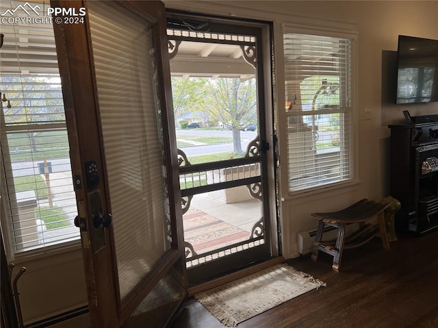 822 Willow St, Trinidad, CO 81082 - doorway to outside with wood finished floors and baseboard heating