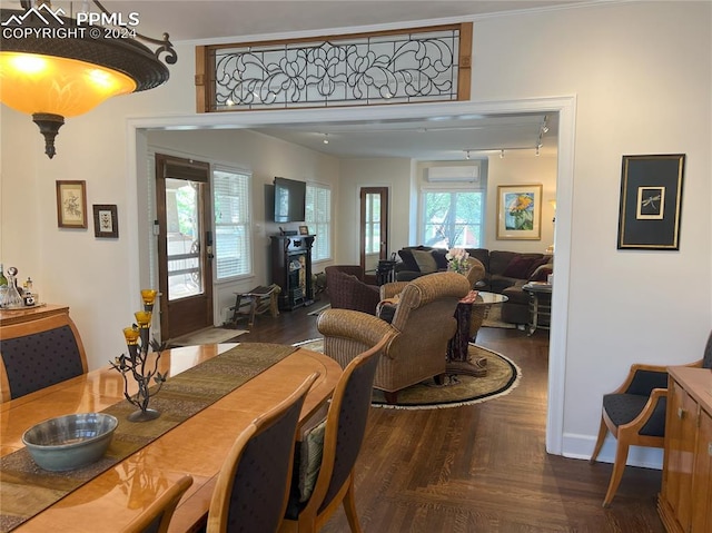 dining room with dark parquet flooring, an AC wall unit, and crown molding