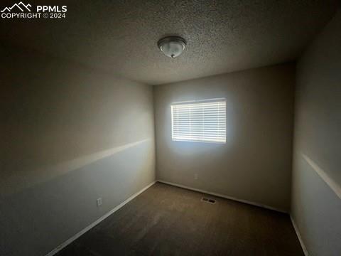 empty room featuring a textured ceiling