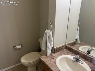 bathroom featuring tile patterned flooring, vanity, and toilet