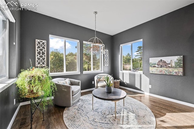 living area featuring a chandelier and hardwood / wood-style flooring