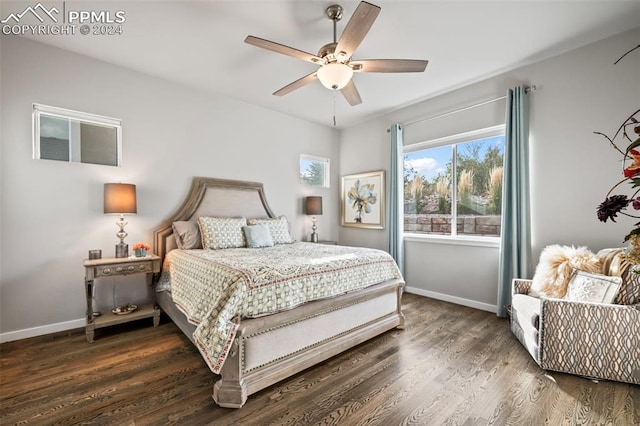 bedroom with dark hardwood / wood-style floors and ceiling fan