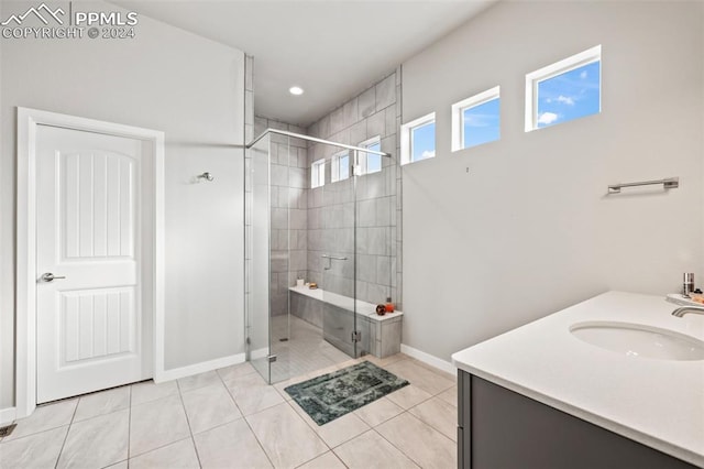 bathroom with tile patterned floors, vanity, and walk in shower