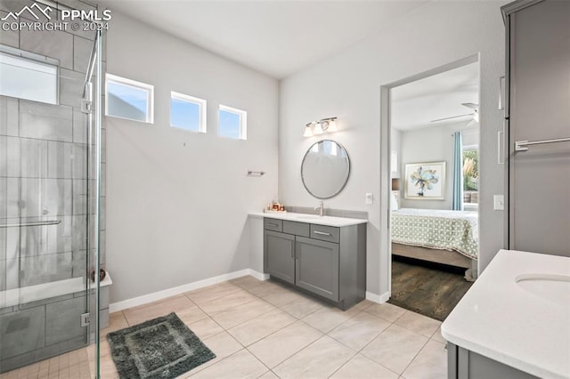 bathroom with an enclosed shower, tile patterned floors, a wealth of natural light, and ceiling fan