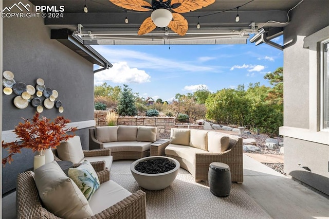 view of patio with an outdoor living space and ceiling fan