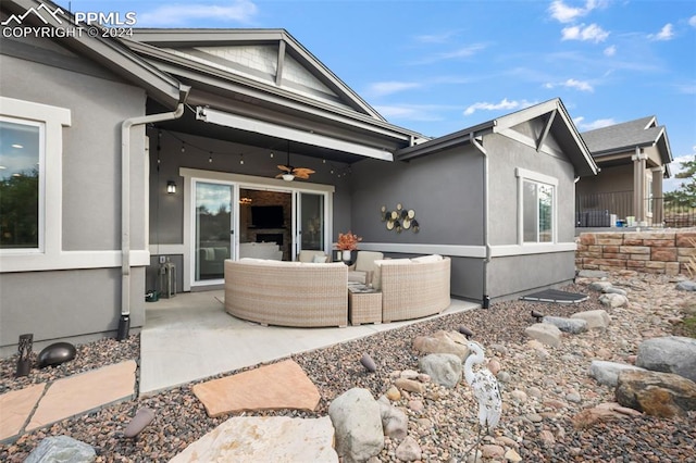 exterior space with a patio area, an outdoor living space, and ceiling fan