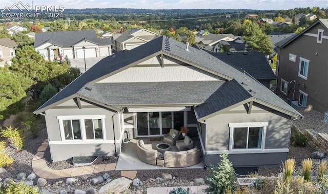 back of property featuring outdoor lounge area and a patio area