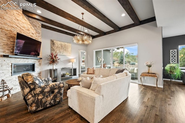 living room with beamed ceiling, a fireplace, dark wood-type flooring, and a chandelier